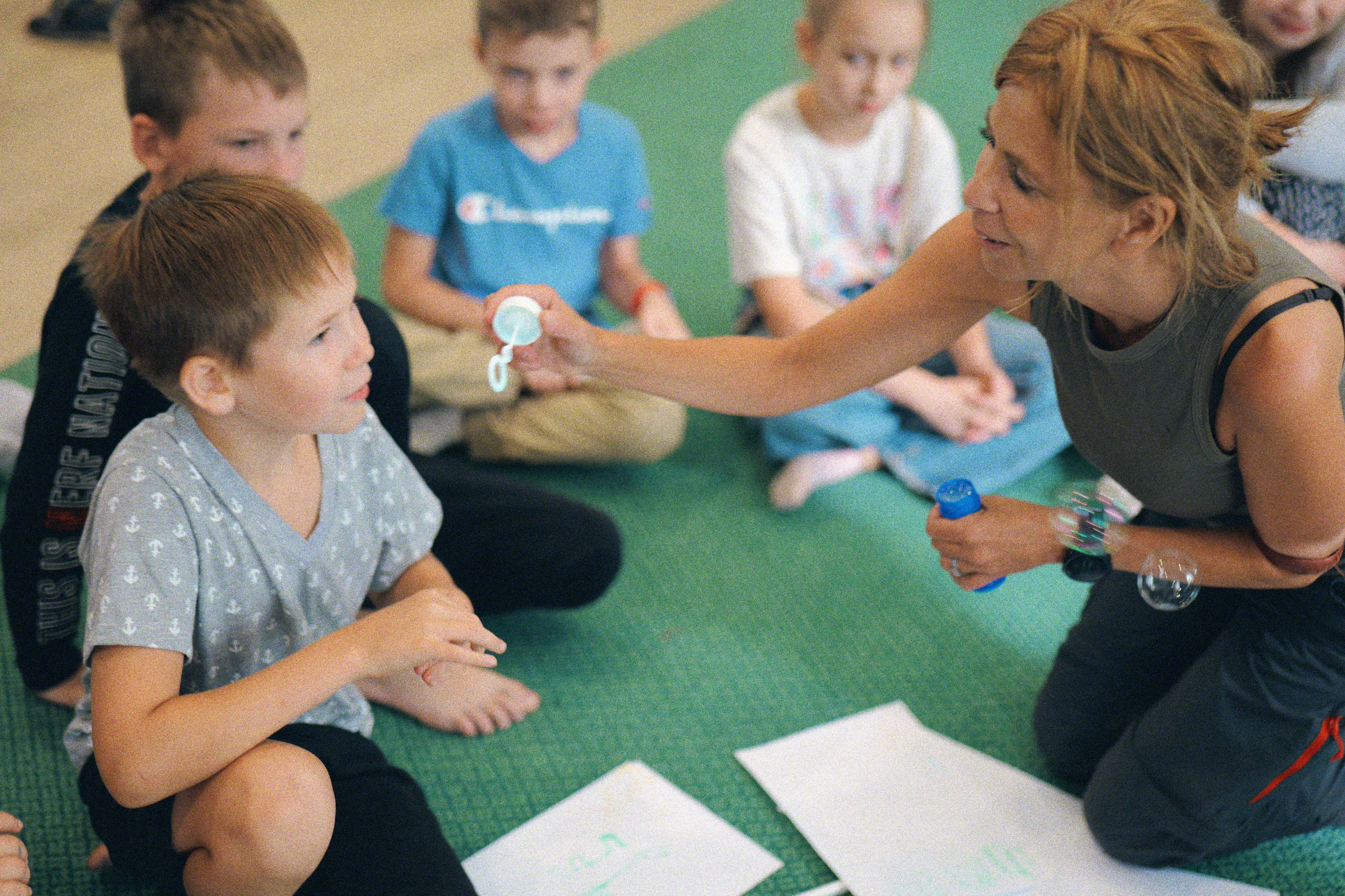 Image: Children sitting in a circle playing a game
