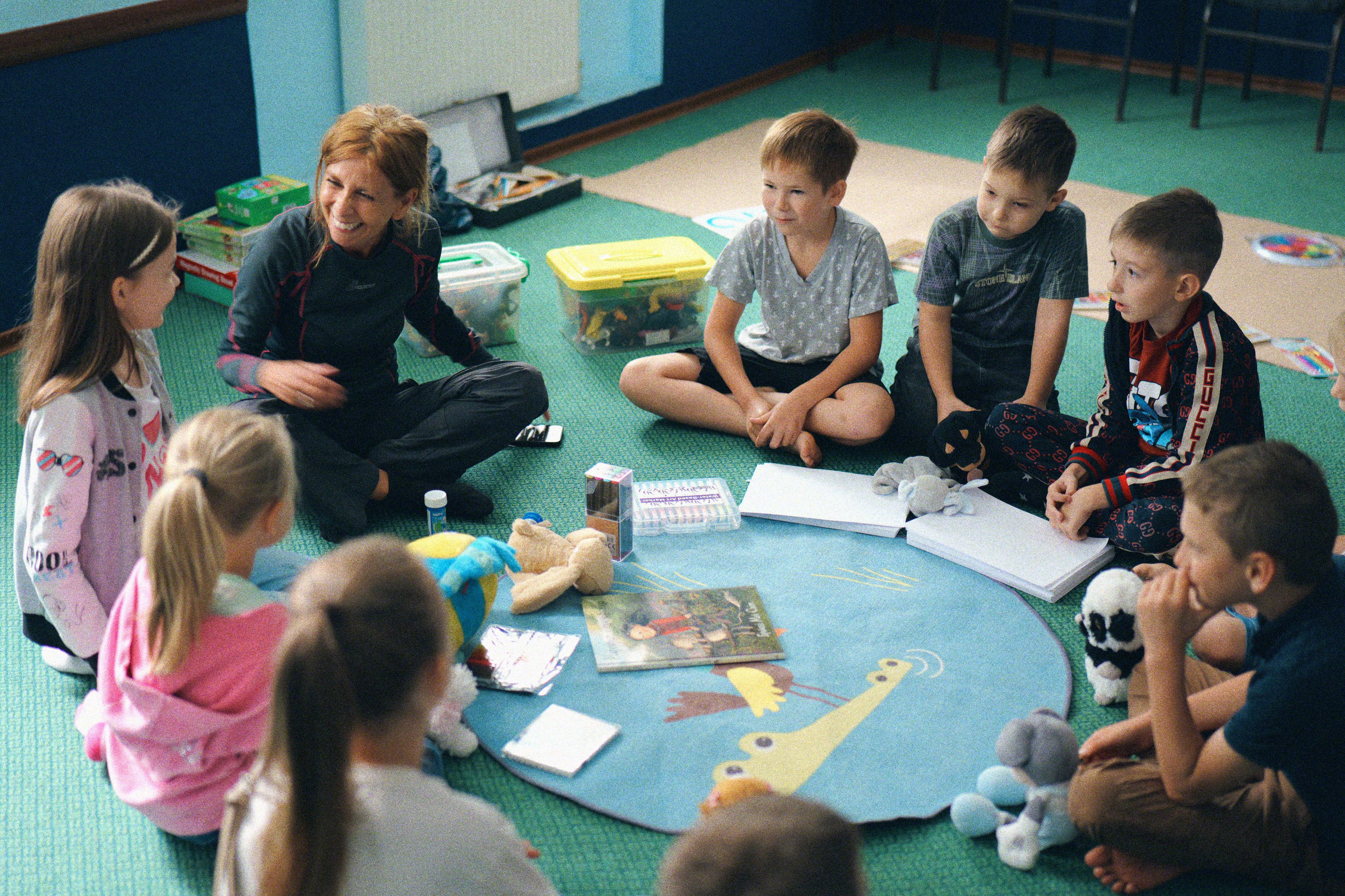 Image: Children sitting in a circle playing a game