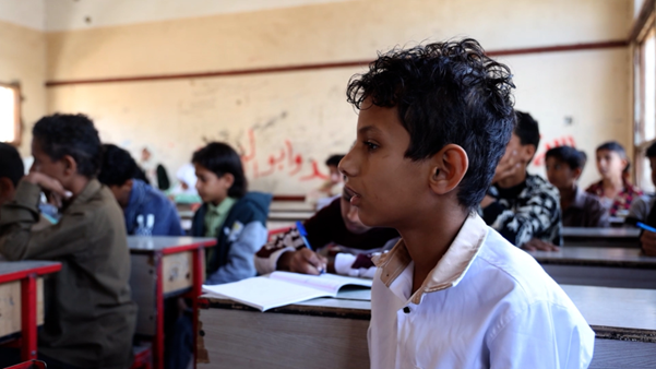 Essam* (12) attending school in a semi-destroyed building that's contaminated by landmines in Taiz, Yemen. © Al-Baraa Mansoor / Save the Children